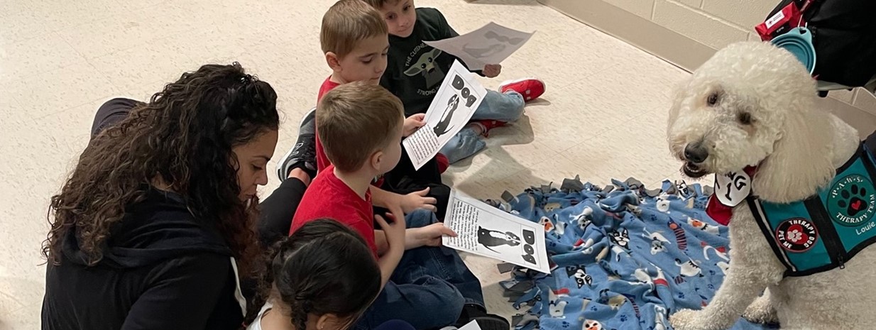 PAWS Therapy Dogs listen to student-read stories!
