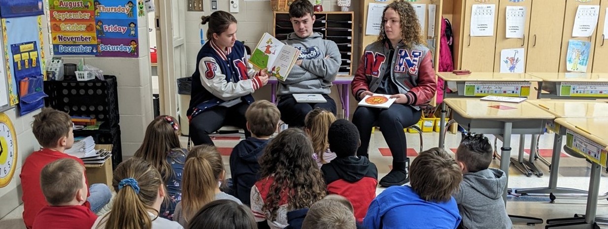 High School Students Read to NPS 1st Graders!