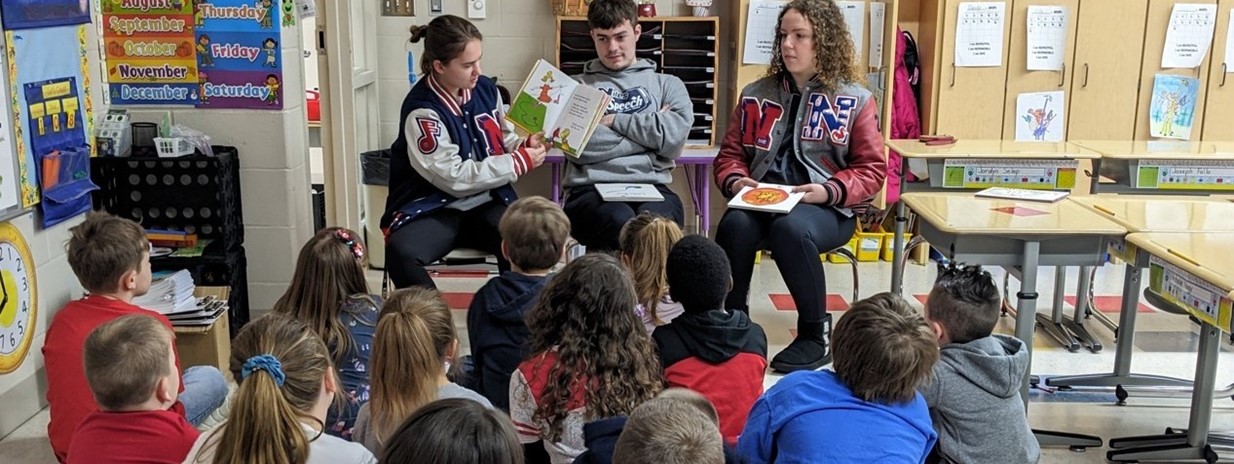 High School Students Read to NPS 1st Graders!