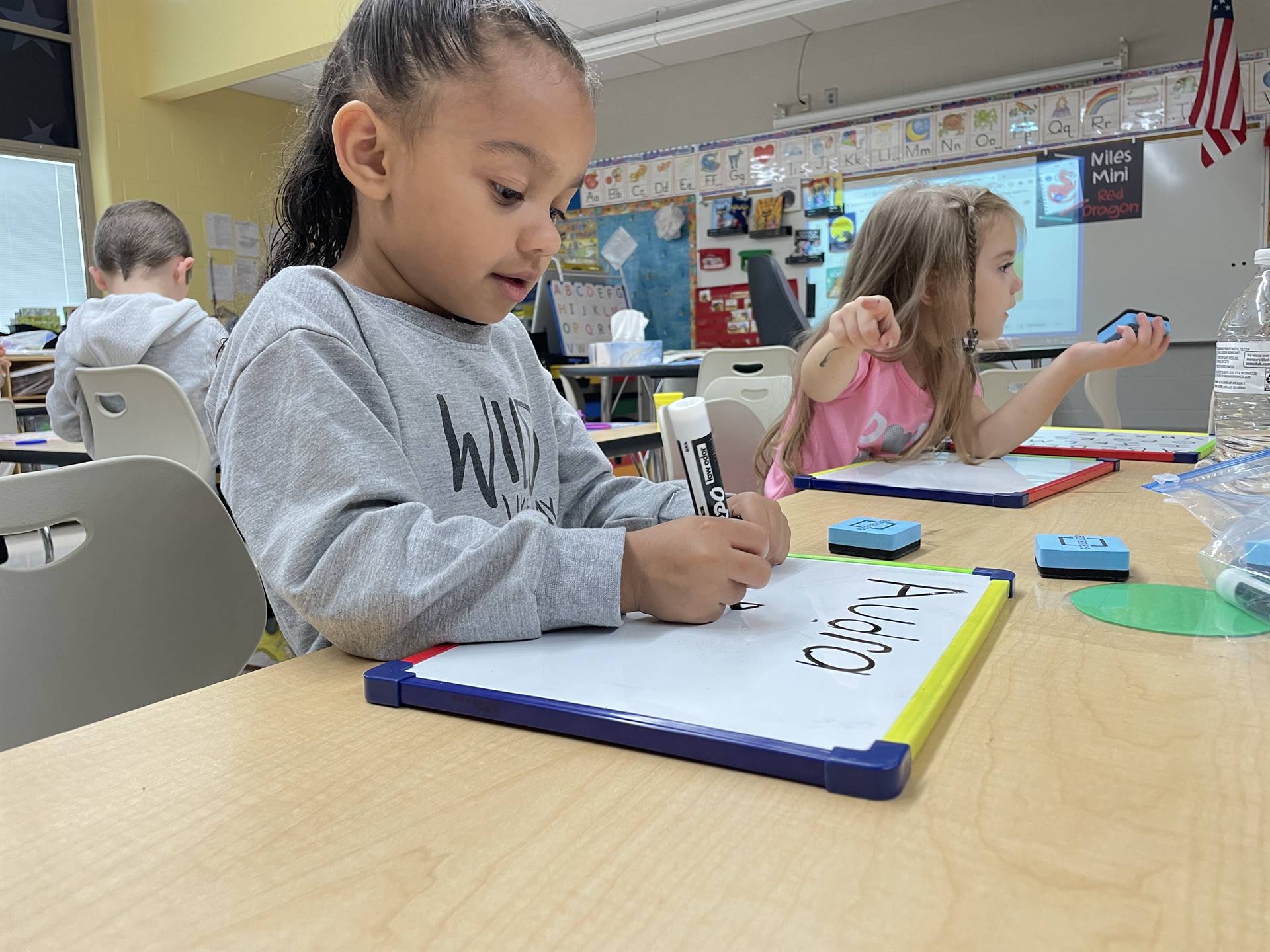 Students practice writing their full name