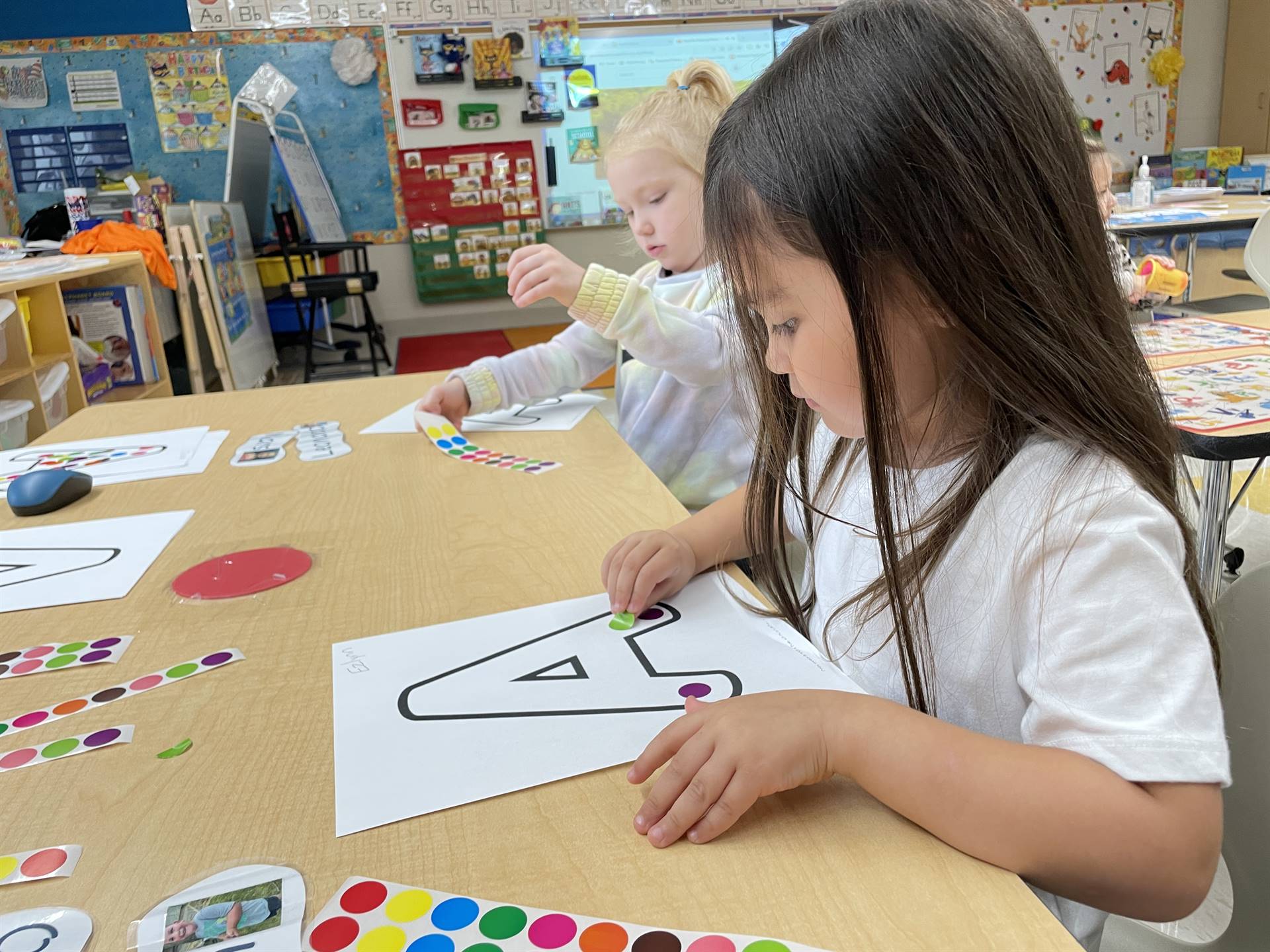 Using stickers to color letters!