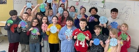 NIS students create colorful snowflakes for a local church to use as décor!