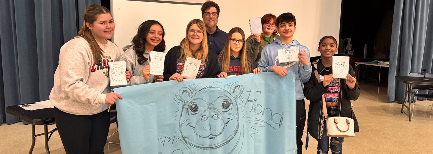 Illustrator Richard Cowdrey (center) shows students how to draw Fiona the Hippo!